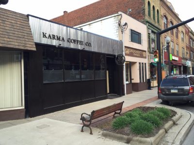 karma coffee sign with black letters on aluminum background